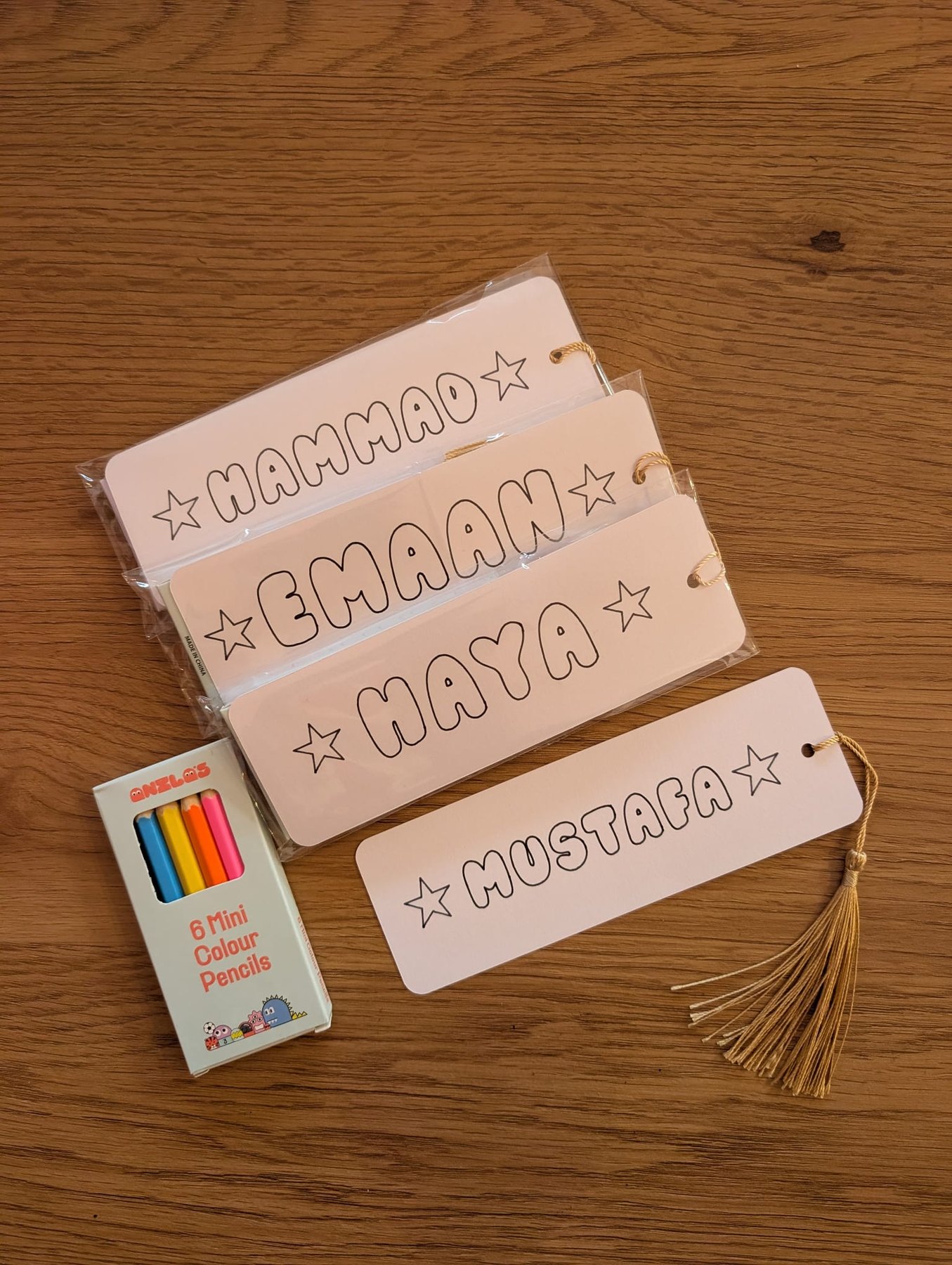 Colour-in name bookmarks for children.